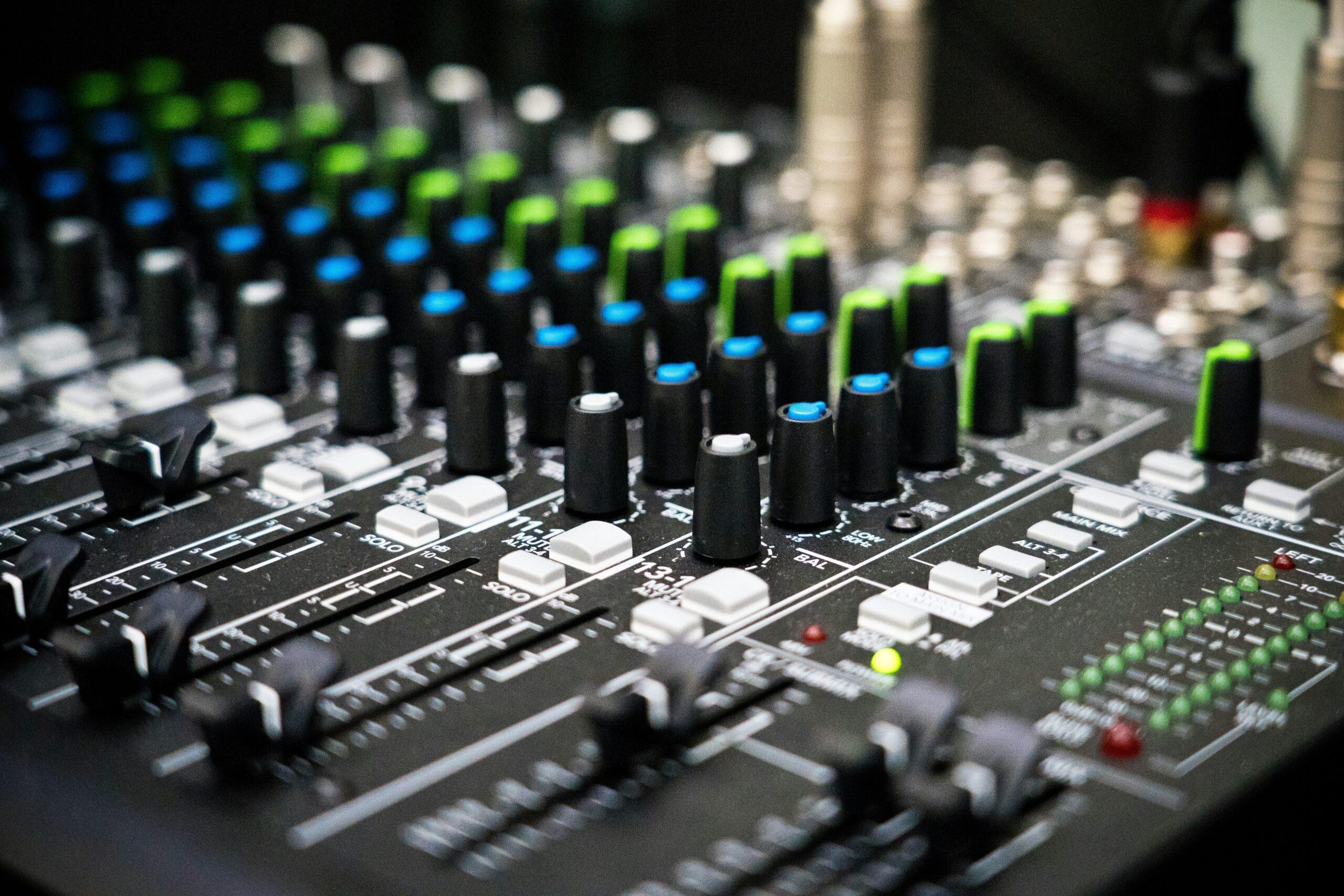 Diagram showing different parts of an audio mixer control panel like faders and knobs