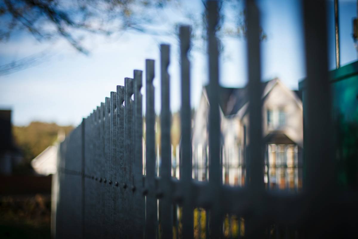 White picket fence in front of a house